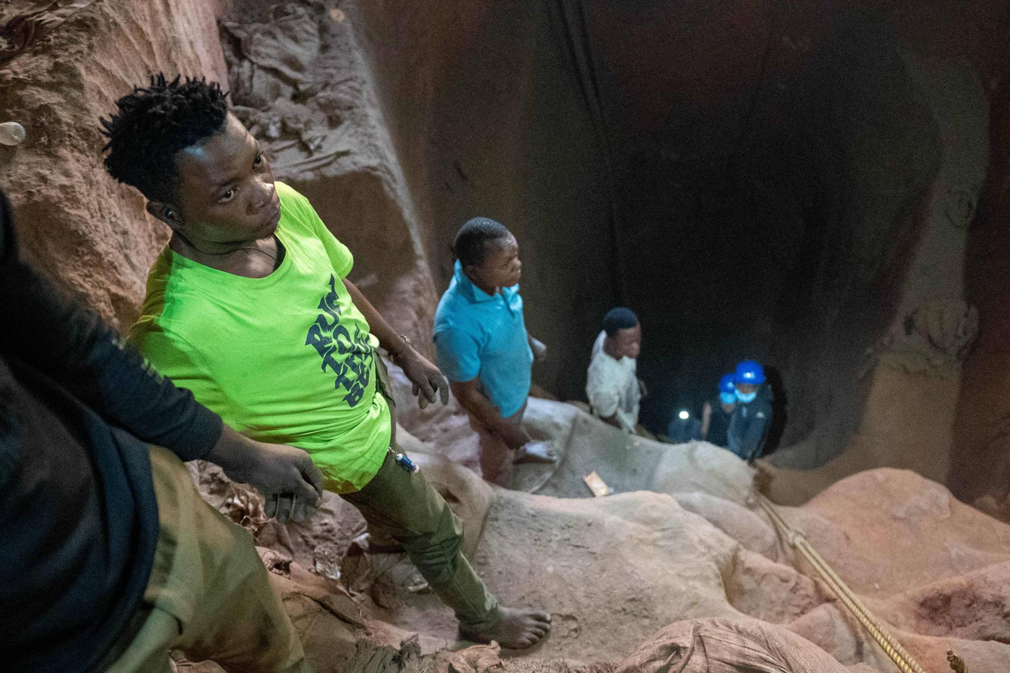 Artisanal miners stand in a shaft in Kamilombe, near the city of Kolwezi, in southeastern Democratic Republic of Congo, on June 20. The Democratic Republic of Congo produces over 70% of the global supply of cobalt. The metal is a critical component of batteries and seen as key to the renewable energy transition. Most of the central African country's cobalt is produced by industrial mines, but the it also has hundreds of thousands of informal diggers who toil in hazardous conditions. | AFP-JIJI