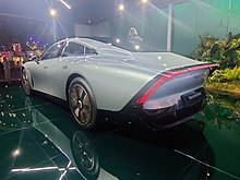 A rear three-quarters view of a silver automobile, the rear is highly tapered off at the top; a brake light bar also following the edge. The bottom of the rear is constructed wholly from carbon fibre, whilst the top is fabricated from steel.