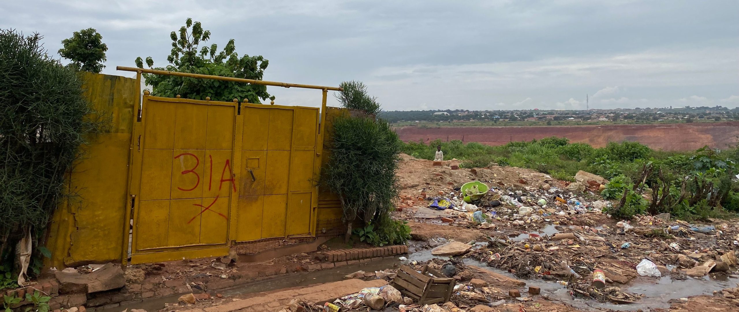 A large yellow door is marked with a red cross for eviction.