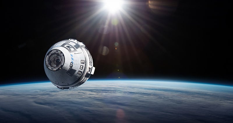 Starliner spaceship in space. Expedition to the International Space Station.