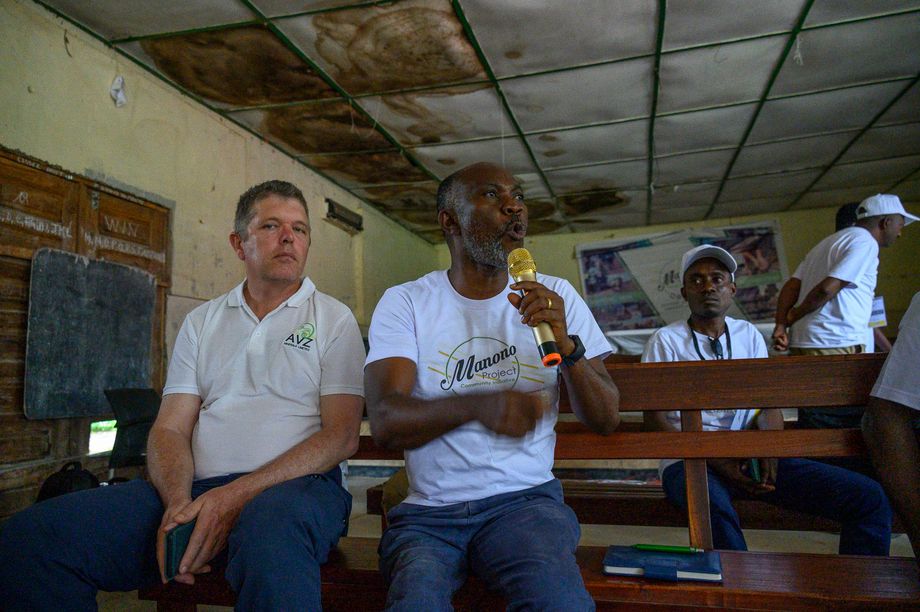 Balthazar Tshiseke (at the microphone) with his colleague Steve Hodgson in the community hall of Manono