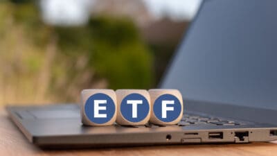 Cubes placed on a Notebook with the letters ETF which stands for Exchange traded funds.