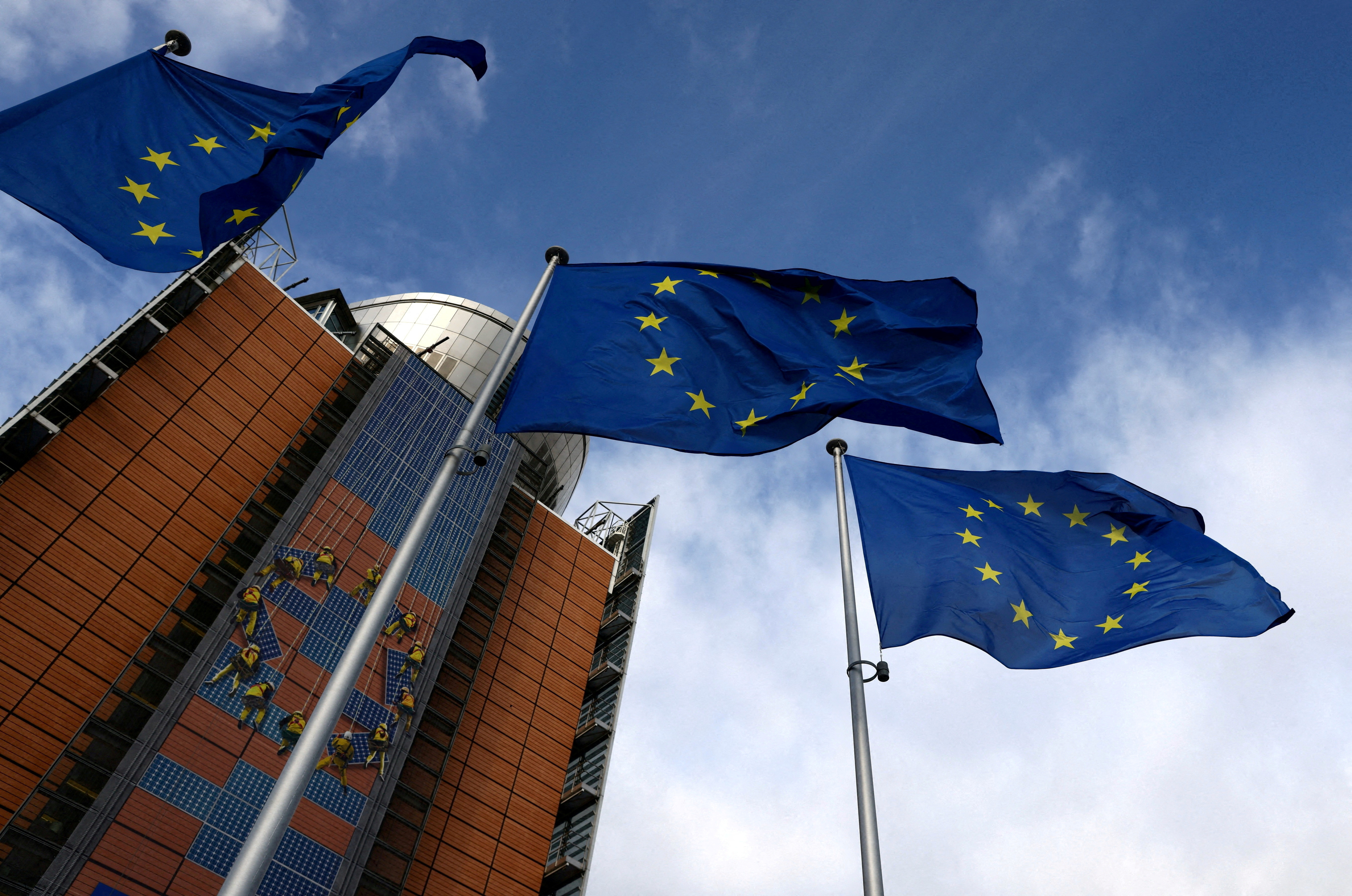 European Union flags flutter outside the EU Commission headquarters in Brussels, Belgium